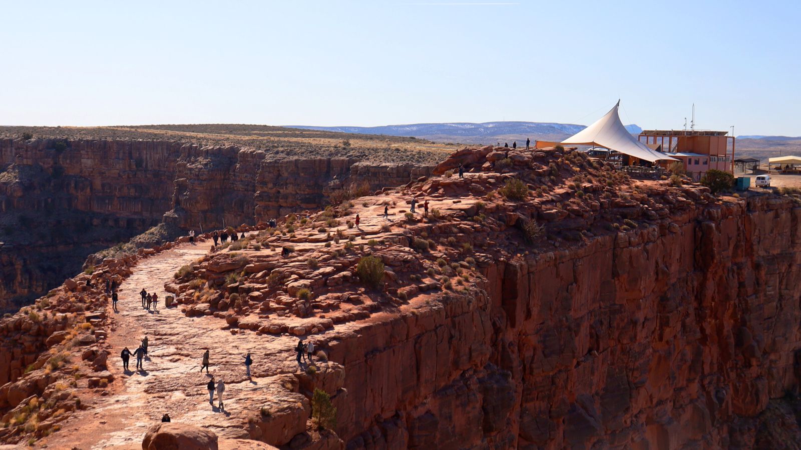several visitors to the Grand Canyon West wander atop Guano Point