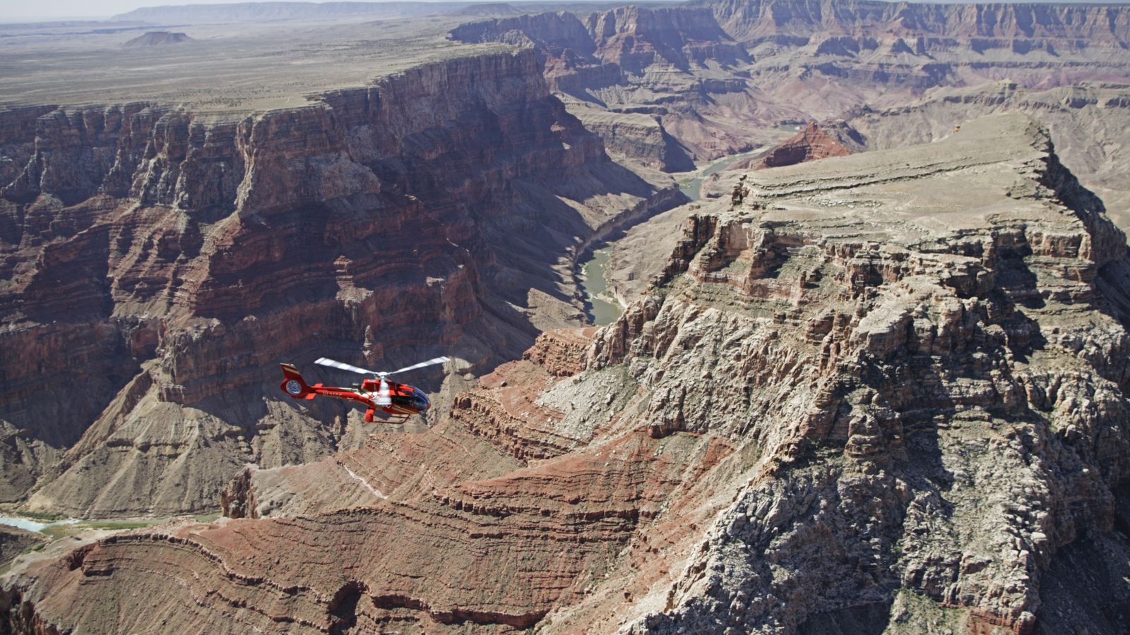 a Grand Canyon helicopter tour flies over a rock gorge