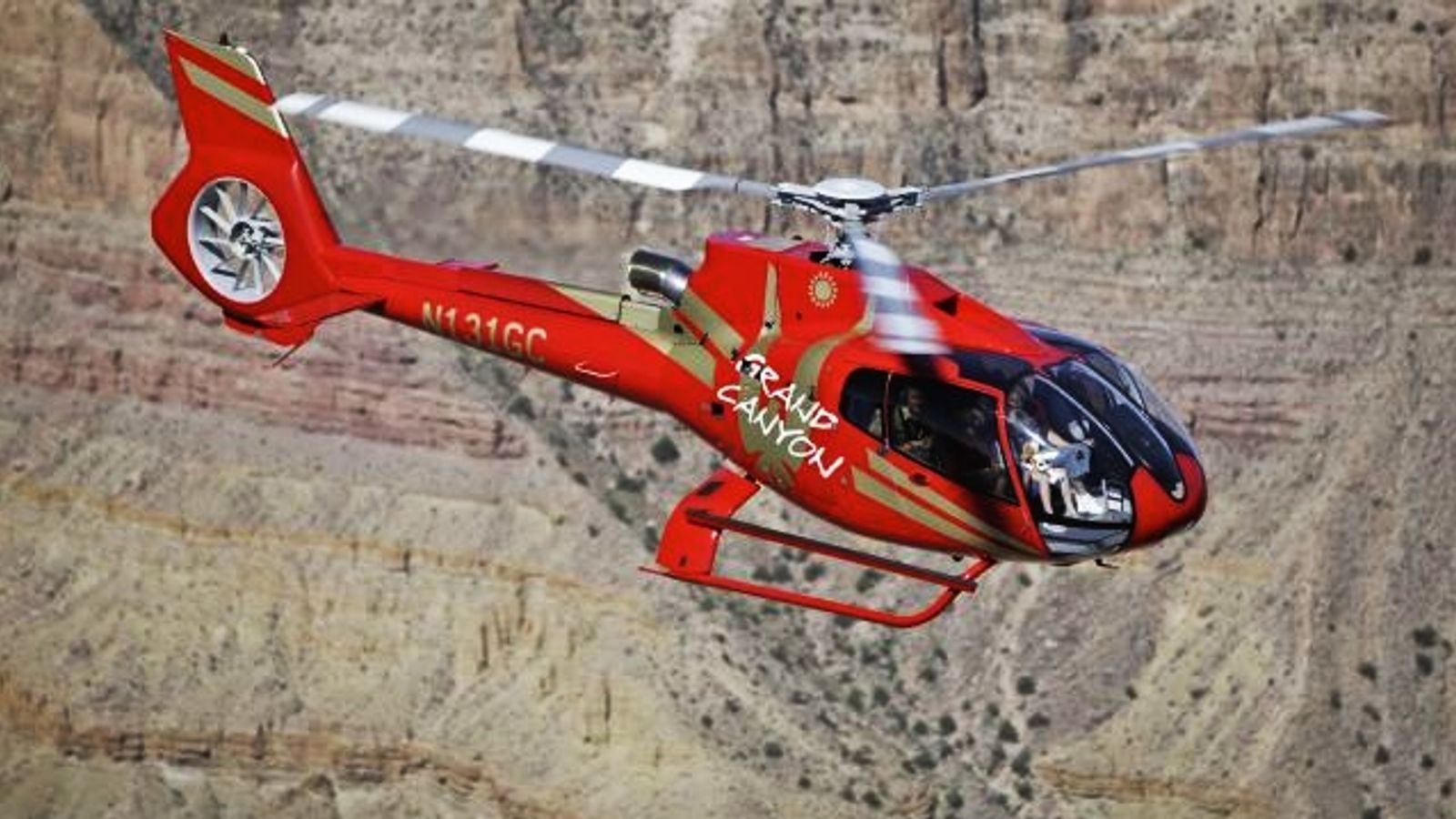 red helicopter tour in flight over grand canyon