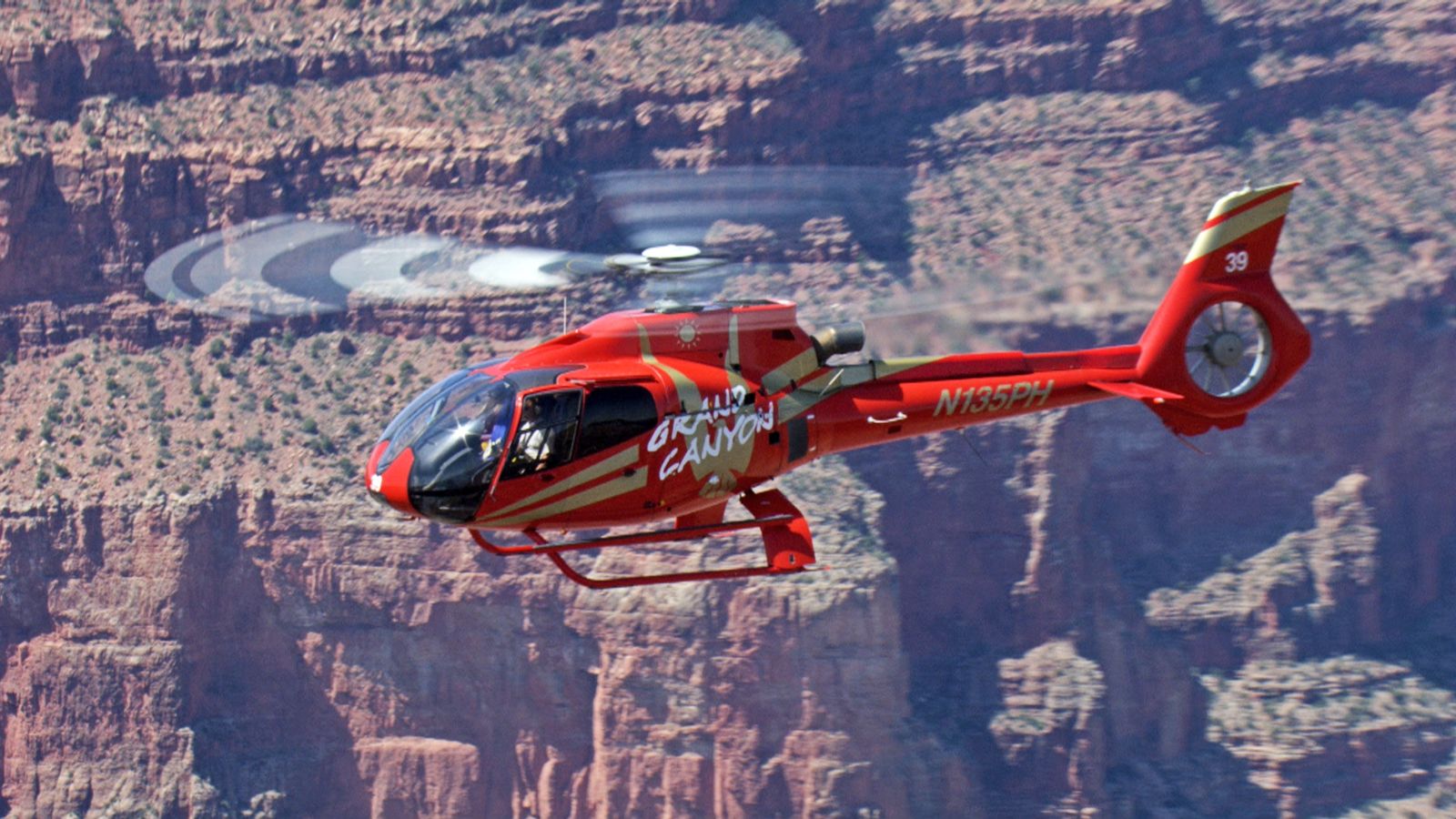 An EcoStar Helicopter as it flies over the Grand Canyon and out into the vast expanse.