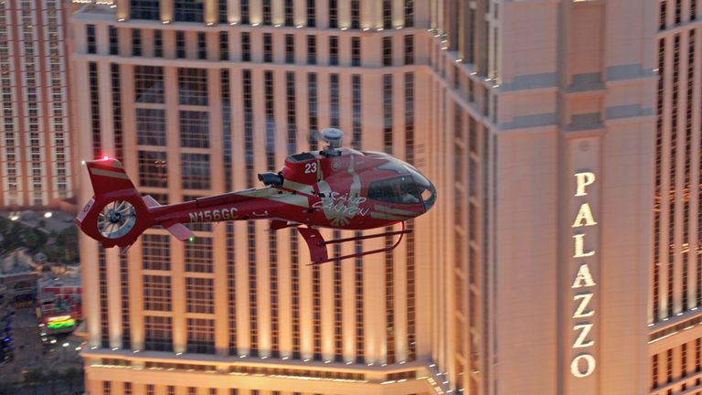 a helicopter flies past the Palazzo hotel sign on a Las Vegas helicopter tour