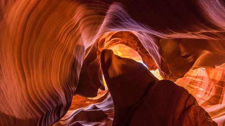 a stunning view taken from the floor of Antelope Canyon featuring rippling sandstone walls