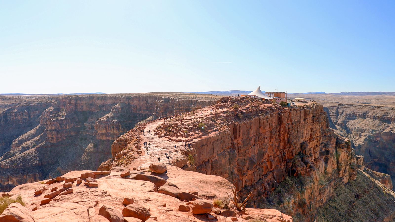 Bright sunny day with people enjoying Grand Canyon West and views of Guano Point and Guano Point Cafe on the Grand Voyager Tour
