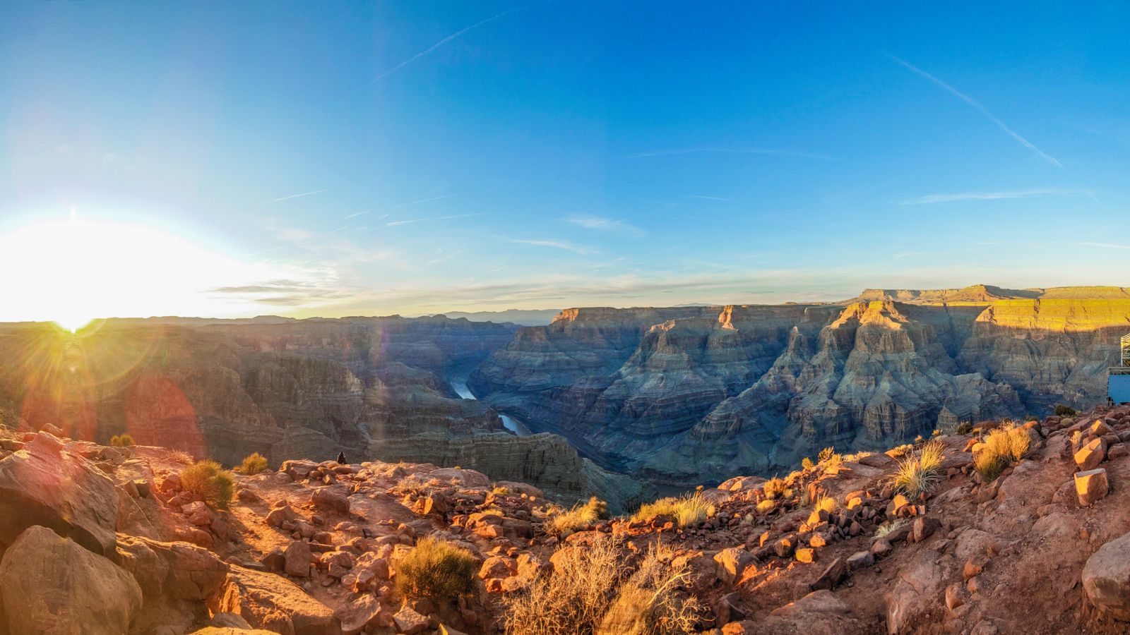Panoramic view of the sun setting at the Grand Canyon West Rim standing on the edge at Guano Point and the Guano Point Mine