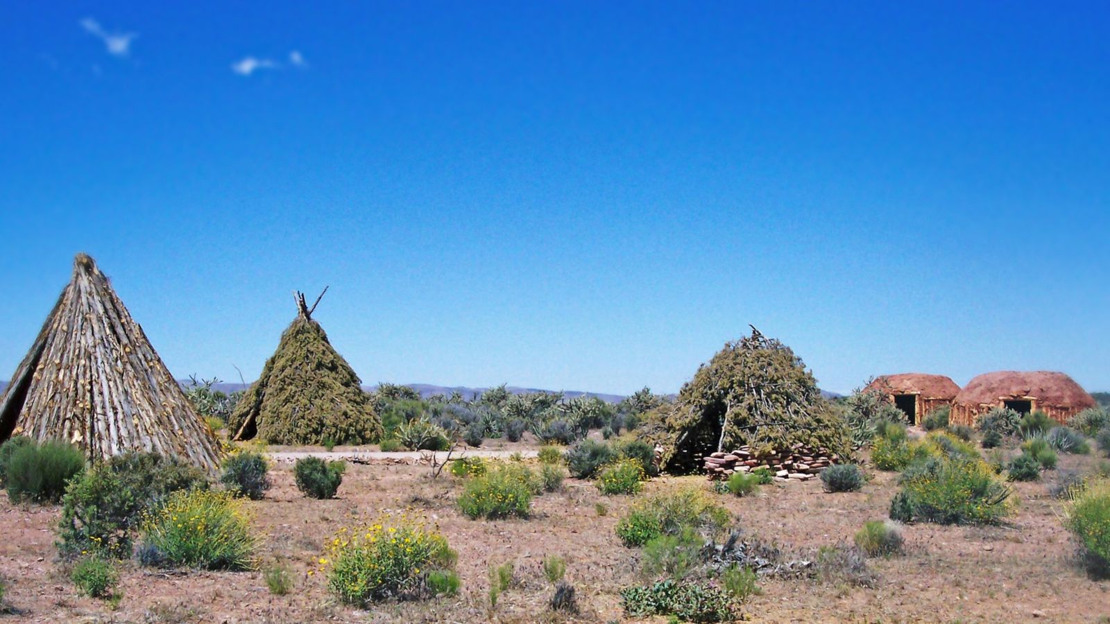 Blue skies and bright sunny day at the Grand Canyon West Rim with views of Native American homes and structures
