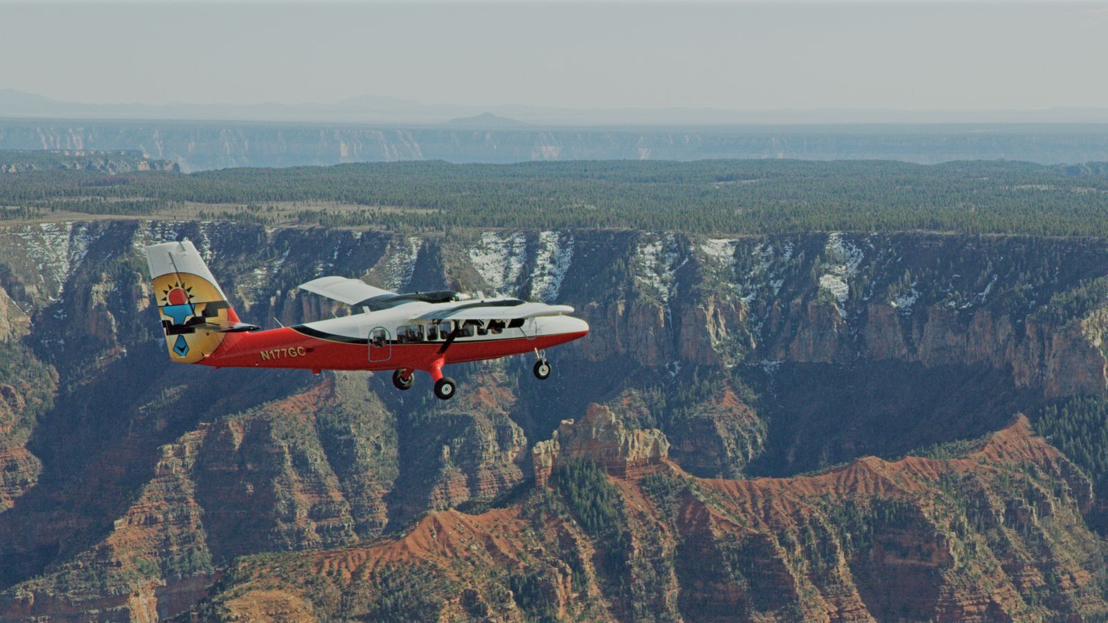 an airplane tour flies over the grand canyon south rim