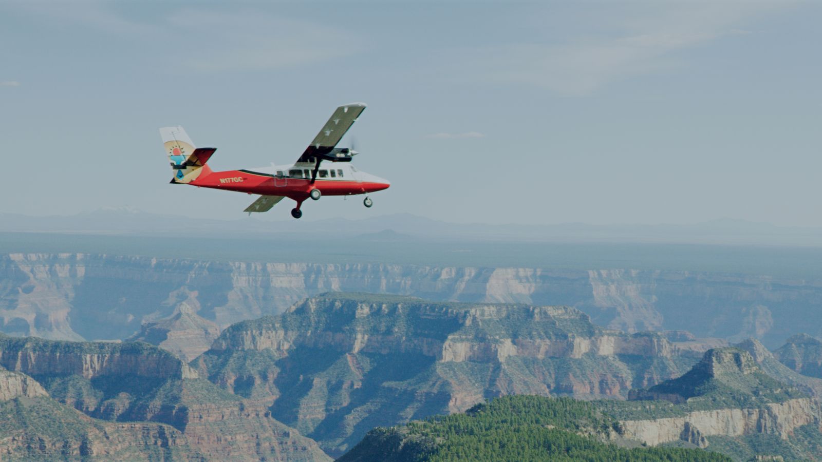 a touring airplane flies over the grand canyon national park