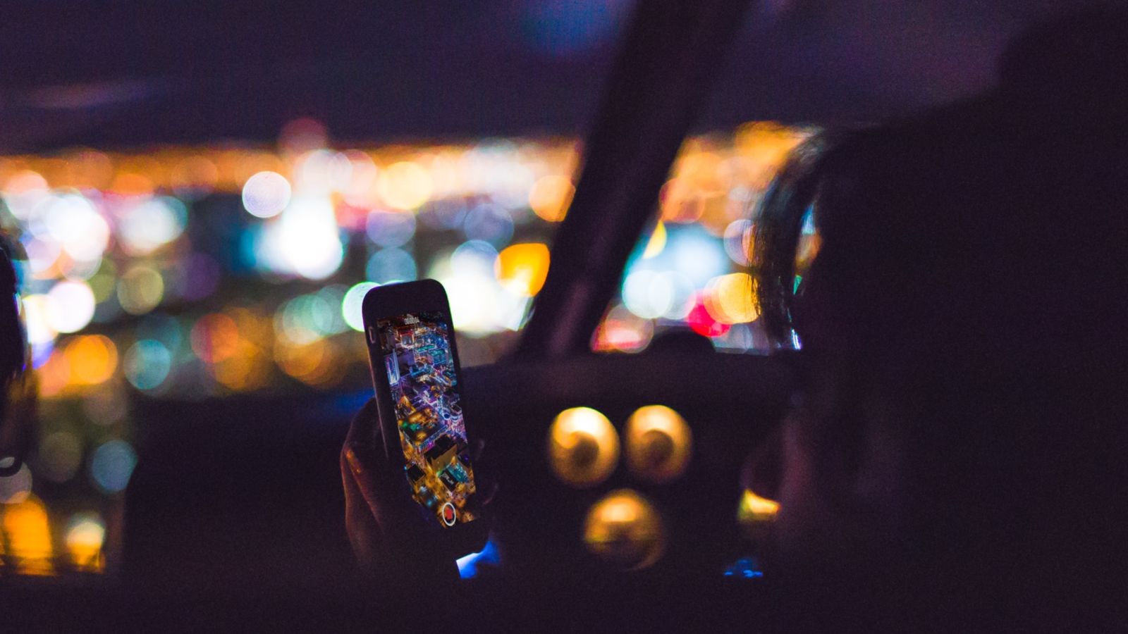 a Las Vegas helicopter tour passenger takes a photo with her phone