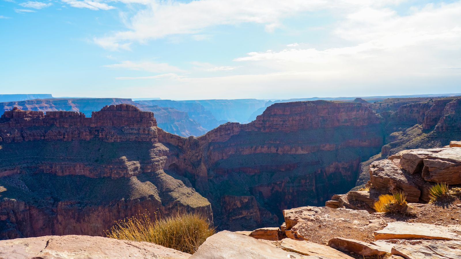 Bright and sunny day at Grand Canyon West Rim with views of Eagle point from the edge of the rim