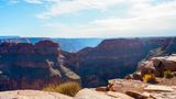 A large rock formation resembling an eagle taking flight within the stone walls of Grand Canyon West