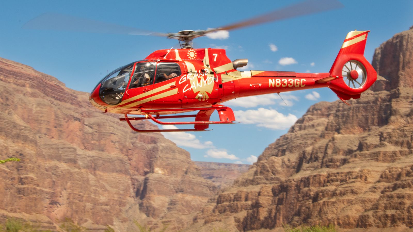 a grand canyon helicopter tour about to land on the floor of the west rim