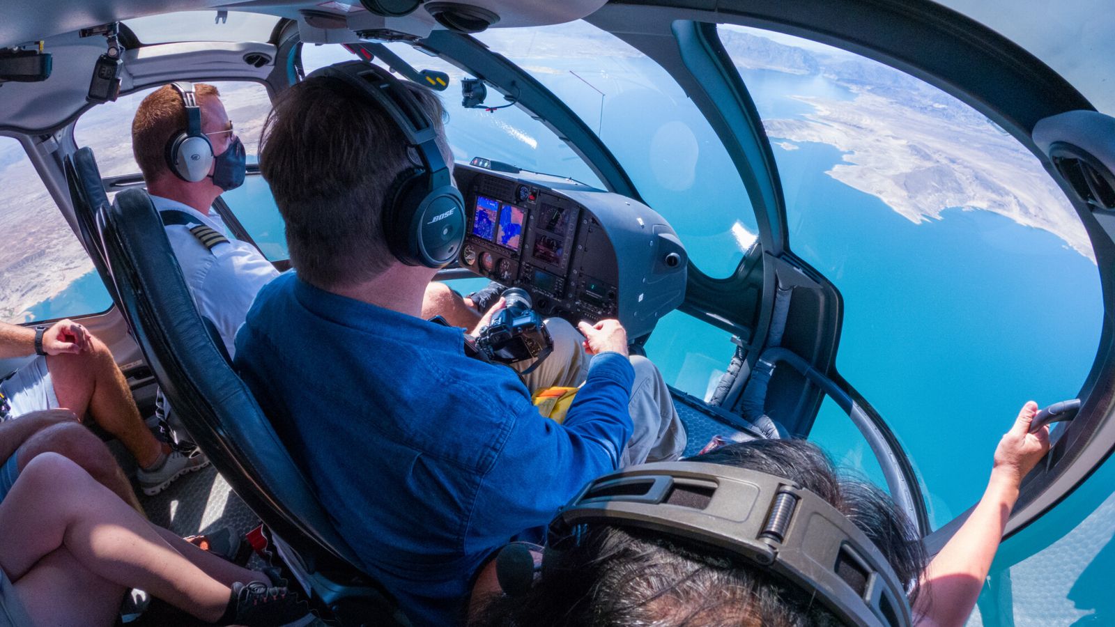 Views of the cockpit looking out of the helicopter flying over Lake Mead.