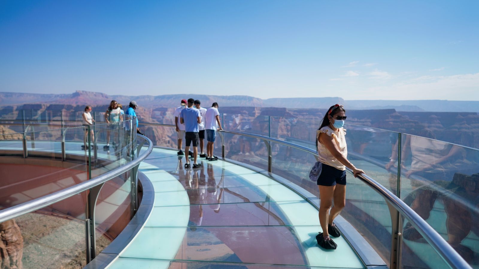 Guests at the Grand Canyon West stand atop the Skywalk glass-bottomed bridge