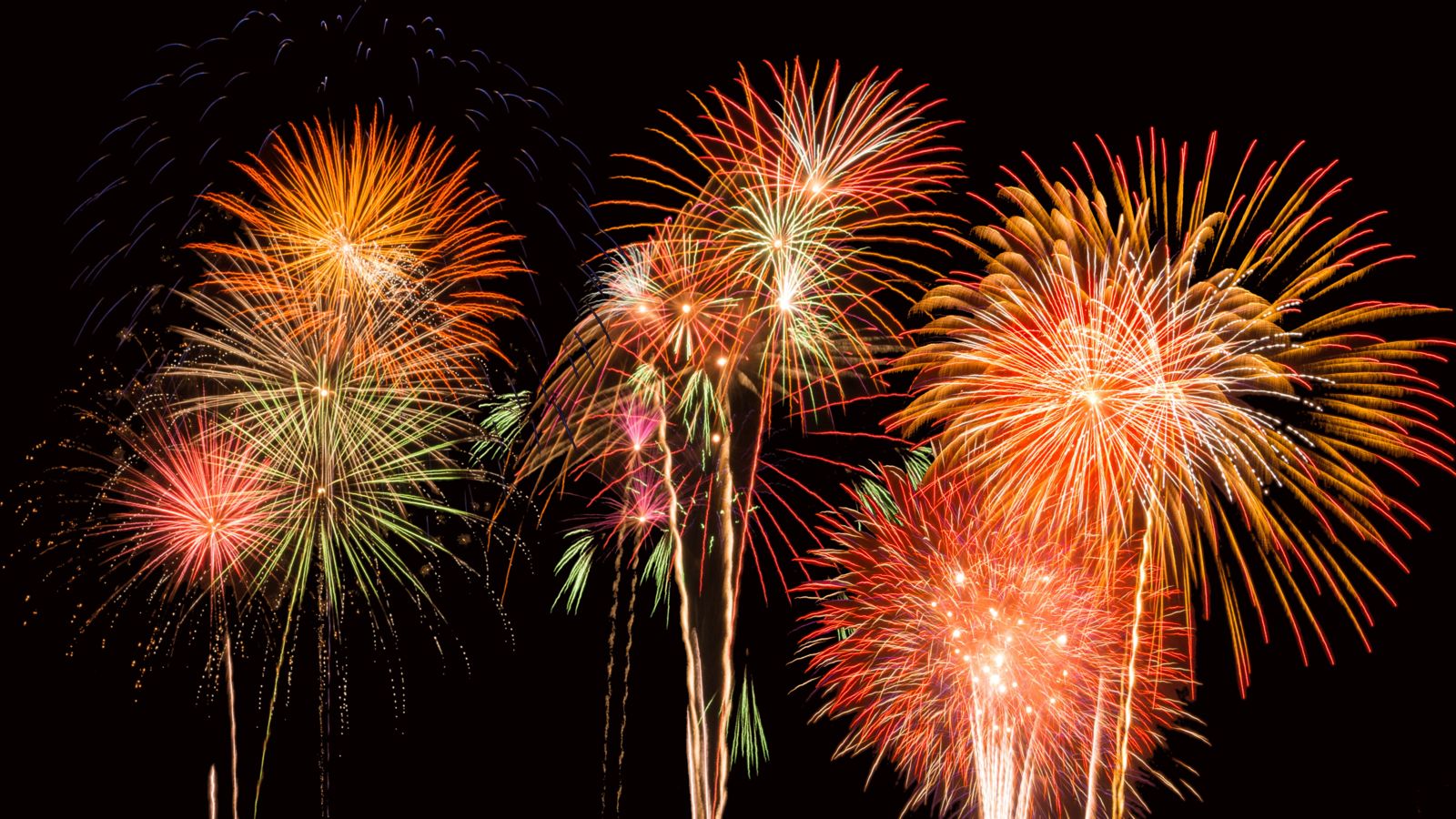 Multiple colors of fireworks in the night sky on July 4th.