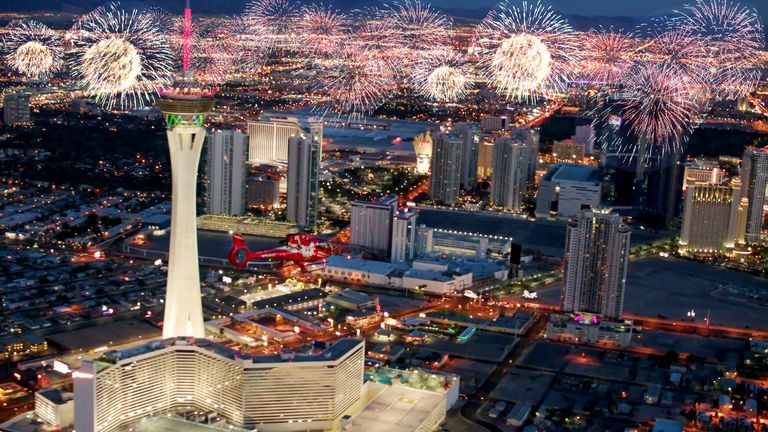 Fireworks photoshop over the Las Vegas Strip for New Year's Eve tour with a red helicopter.