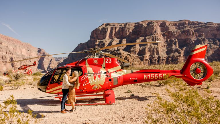 Helicopter passengers standing next to the aircraft