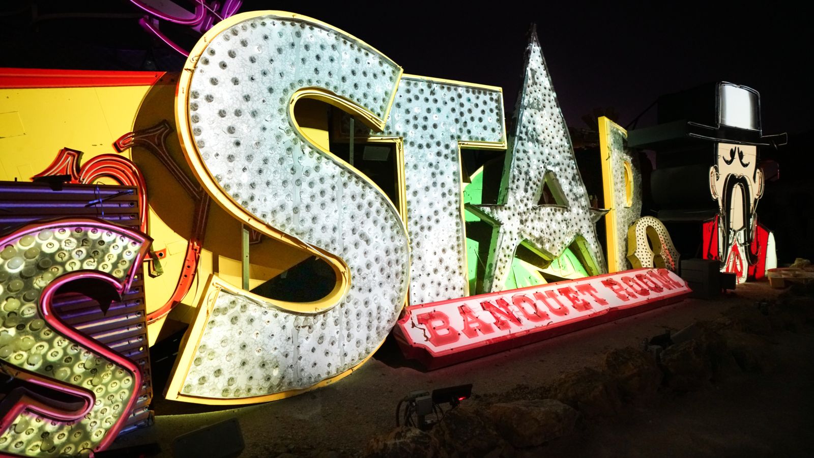 several neon signs displayed at the Las Vegas Neon Museum