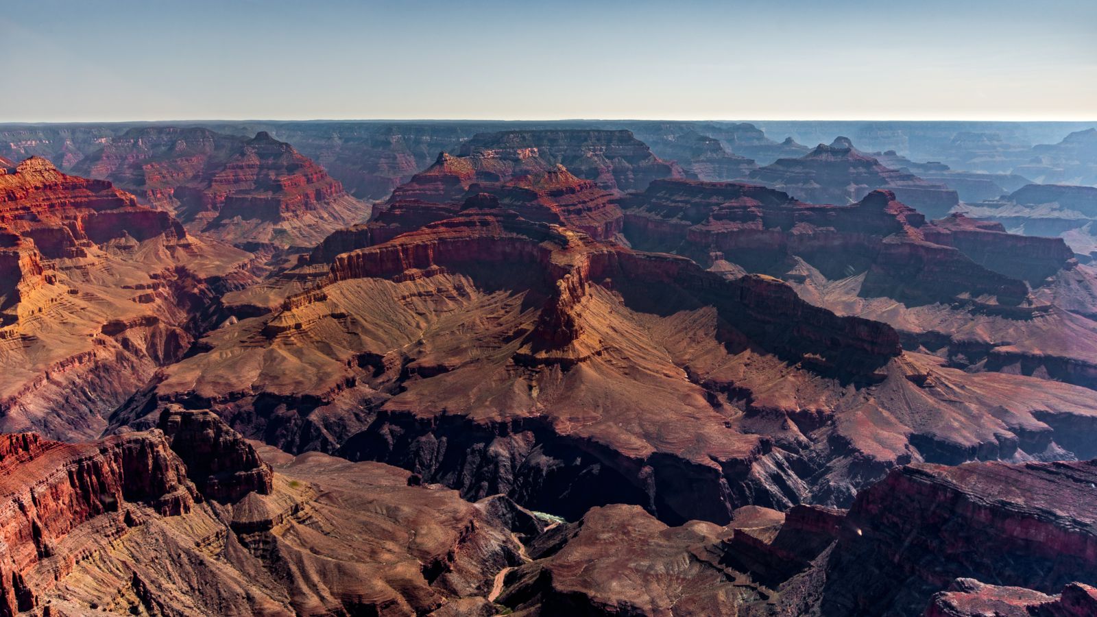 A rainbow livery helicopter flying the Dragon Corridor at Grand Canyon