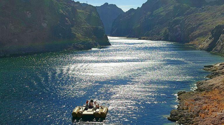 A raft floating on the Colorado River in Black Canyon