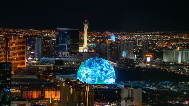 Aerial views of illuminated MSG Sphere from a helicopter