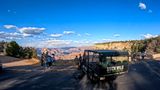 a tour group stands at a famous Grand Canyon National Park lookout point