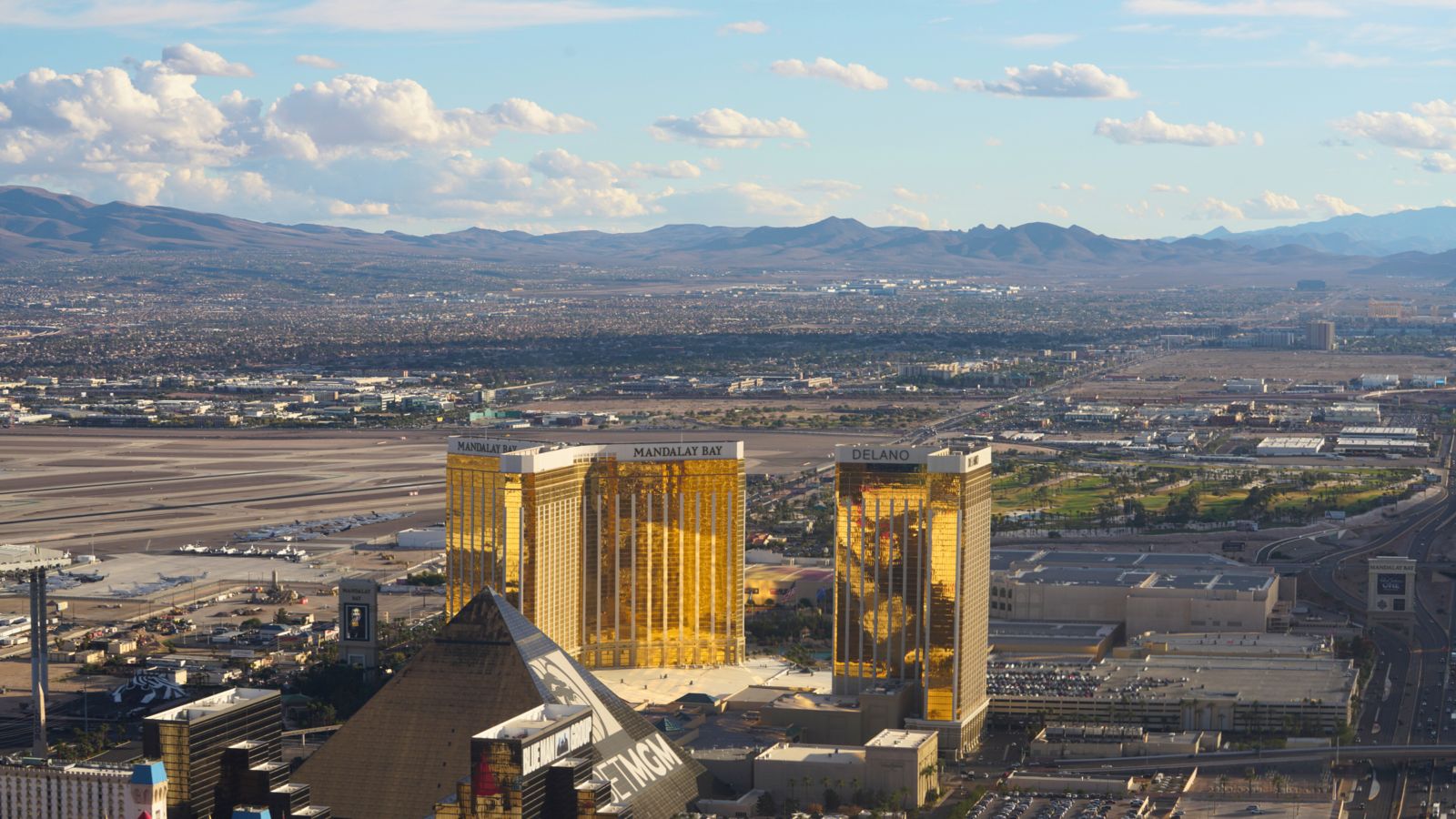 the mandalay bay and delano hotels seen from a las vegas helicopter tour with mountains in the background