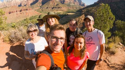 visitors to Zion National Park stand amidst the wild scenery