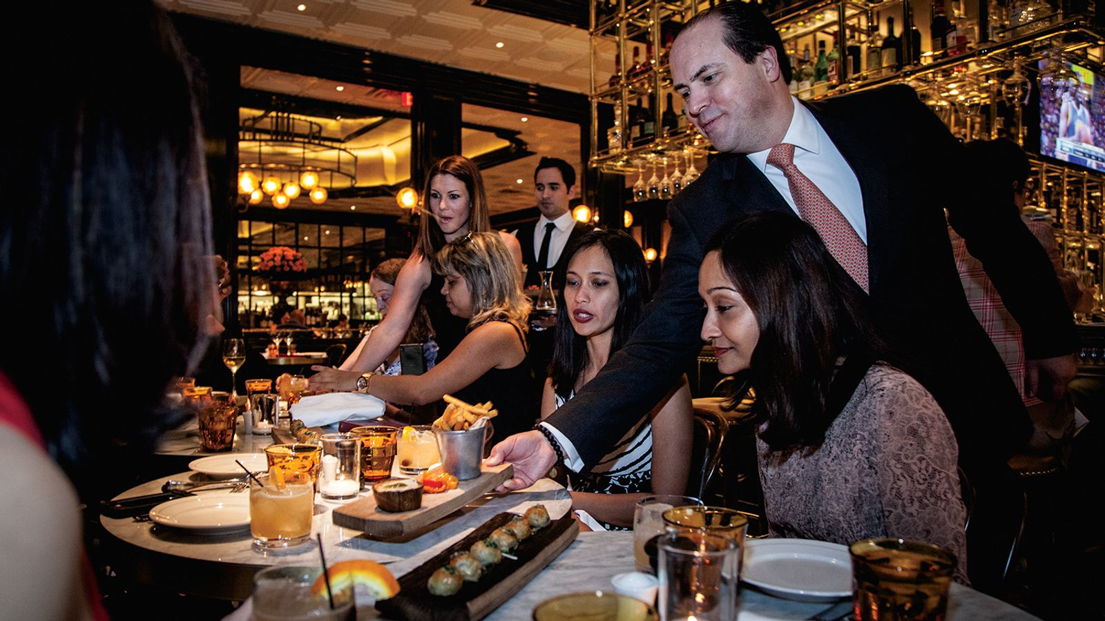 Guests participating in a Las Vegas foodie tour being served luxury  dishes