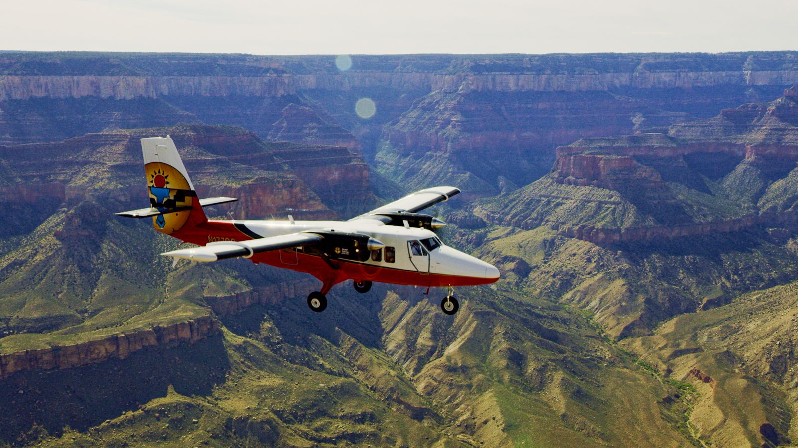 A Grand Canyon airplane tour soars over the sun-kissed walls of the South Rim