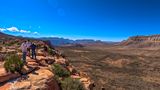 Visitors to Bar 10 Ranch stand at a scenic canyon overlook