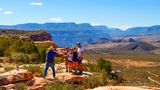 A family at Bar 10 Ranch getting their photo taken at a scenic viewpoint