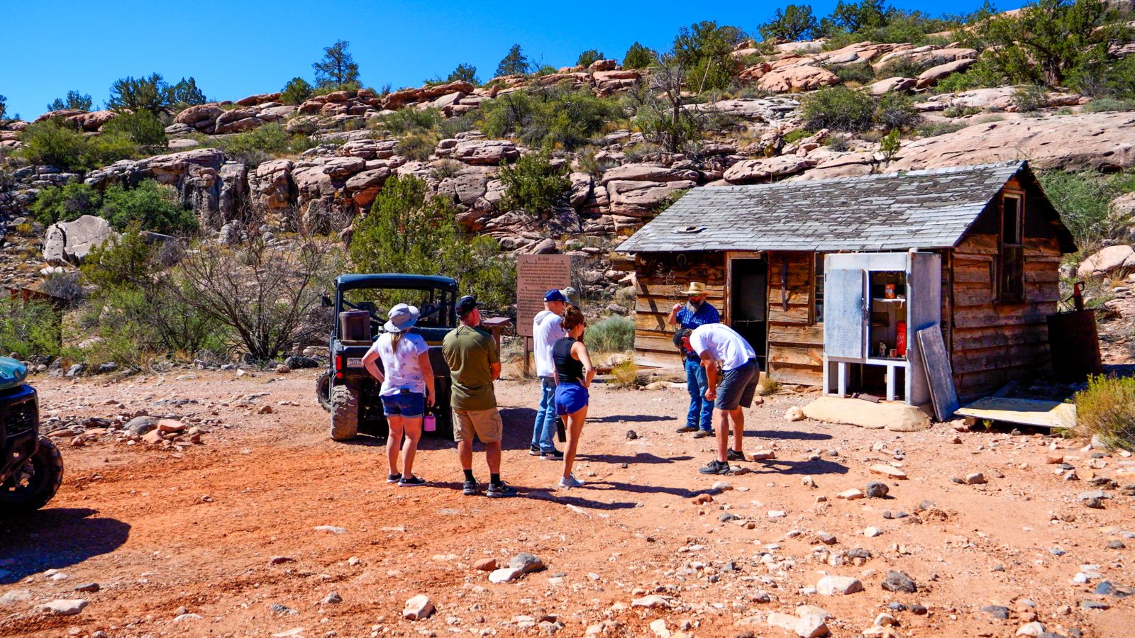 An off-roading tour group exploring old cabins at Bar 10 Ranch