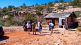 An off-roading tour group exploring old cabins at Bar 10 Ranch