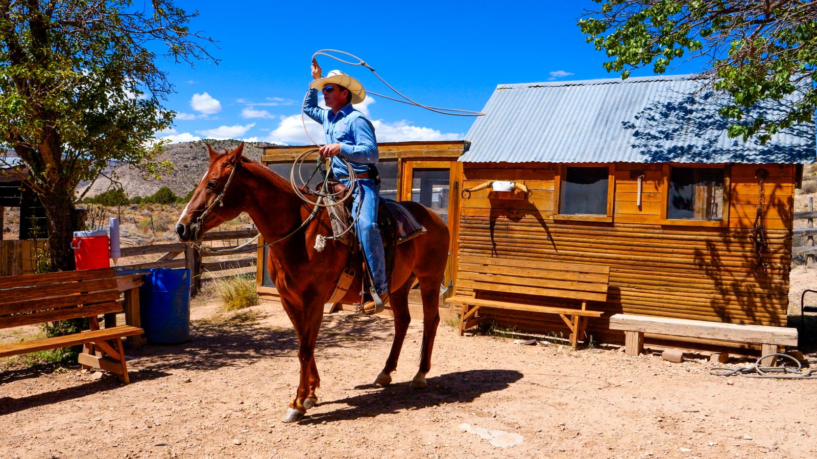 A Bar 10 ranch worker shows off his roping skills on a horse