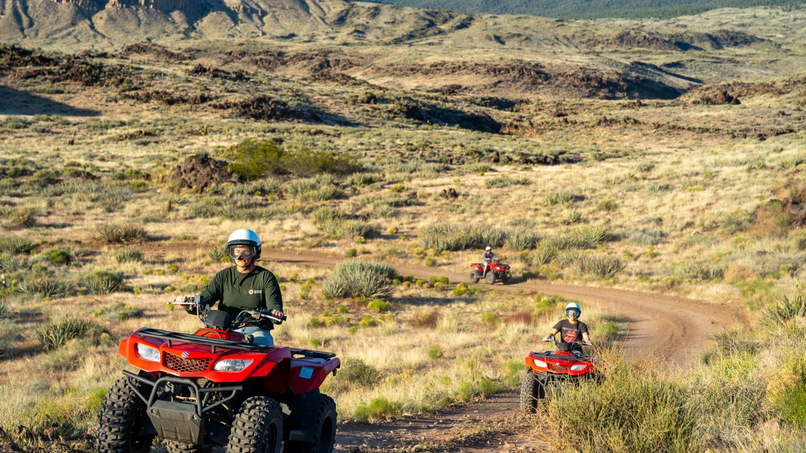 Bar 10 Ranch visitors riding ATVs in the nearby desert landscape