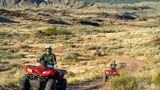 Bar 10 Ranch visitors riding ATVs in the nearby desert landscape
