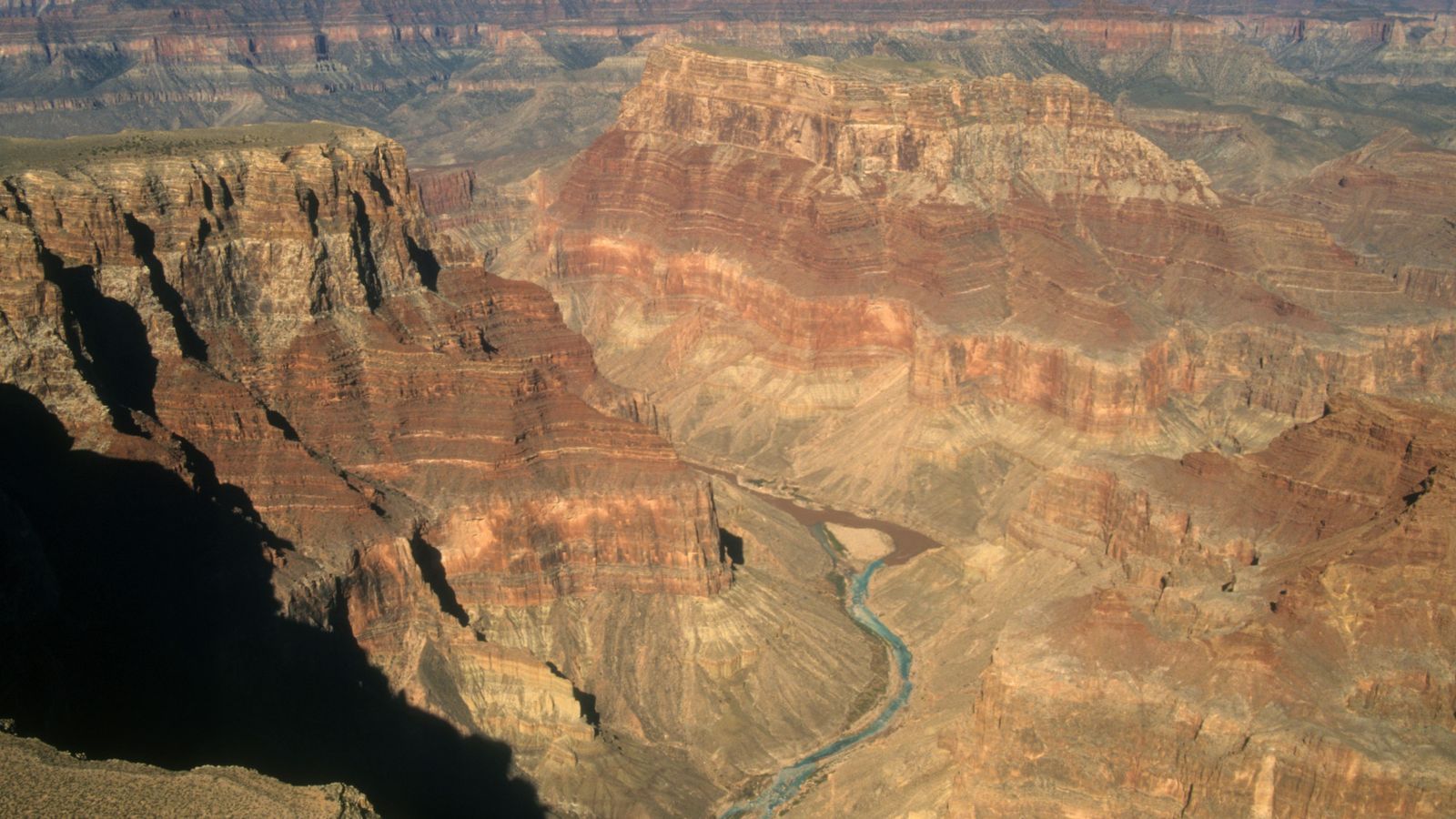 The colorado river merging with the little colorado river seen from an airplane tour over the grand canyon