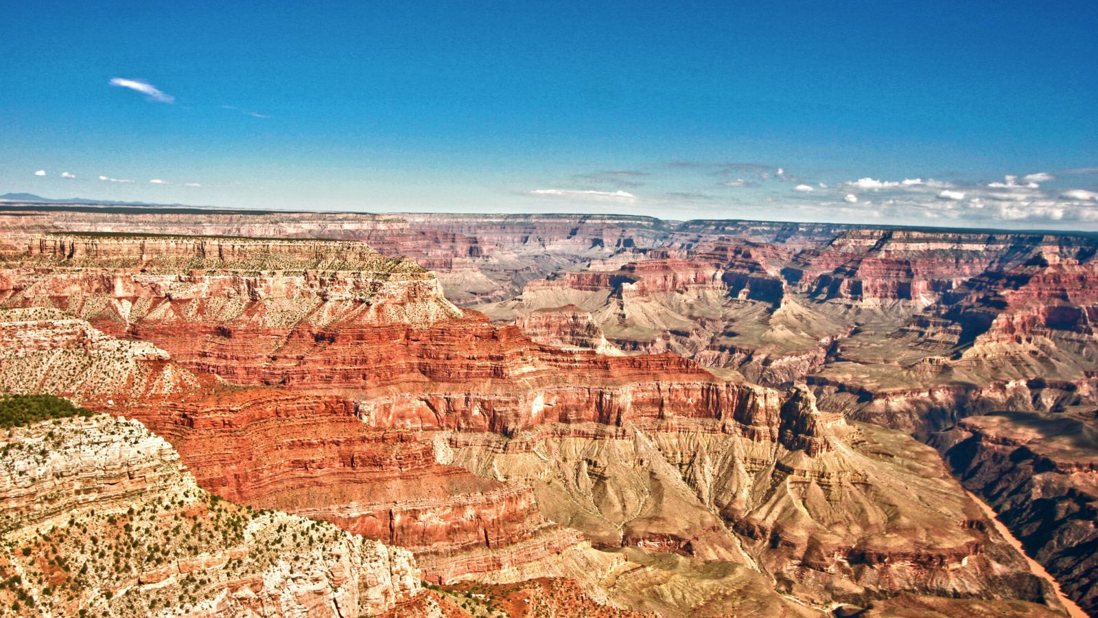 an airplane tour flies through a clear blue sky over the grand canyon national park