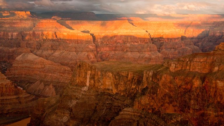 the red striped walls of the Grand Canyon West at sunset