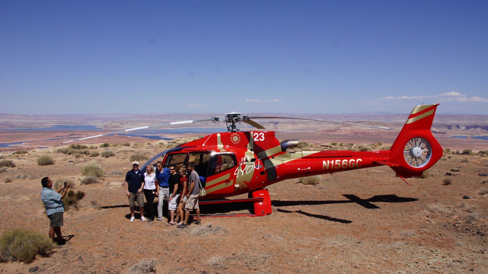 Taking a group picture in front of the helicopter while landed at tower butte near Horseshoe Bend and Antelope Canyon