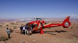 Taking a group picture in front of the helicopter while landed at tower butte near Horseshoe Bend and Antelope Canyon