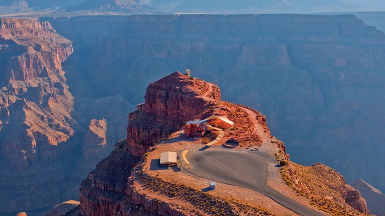 Guano Point, a stone peninsula within the Grand Canyon West , extends into the canyon gorge where a white tent is placed at the end