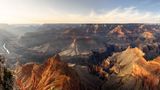 View of the Grand Canyon South Rim with the sun shining from the left side and the Colorado River seen below.