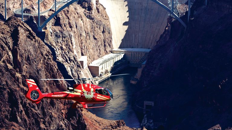 Las Vegas helicopter tour flies over desert landscape with Hoover Dam in background