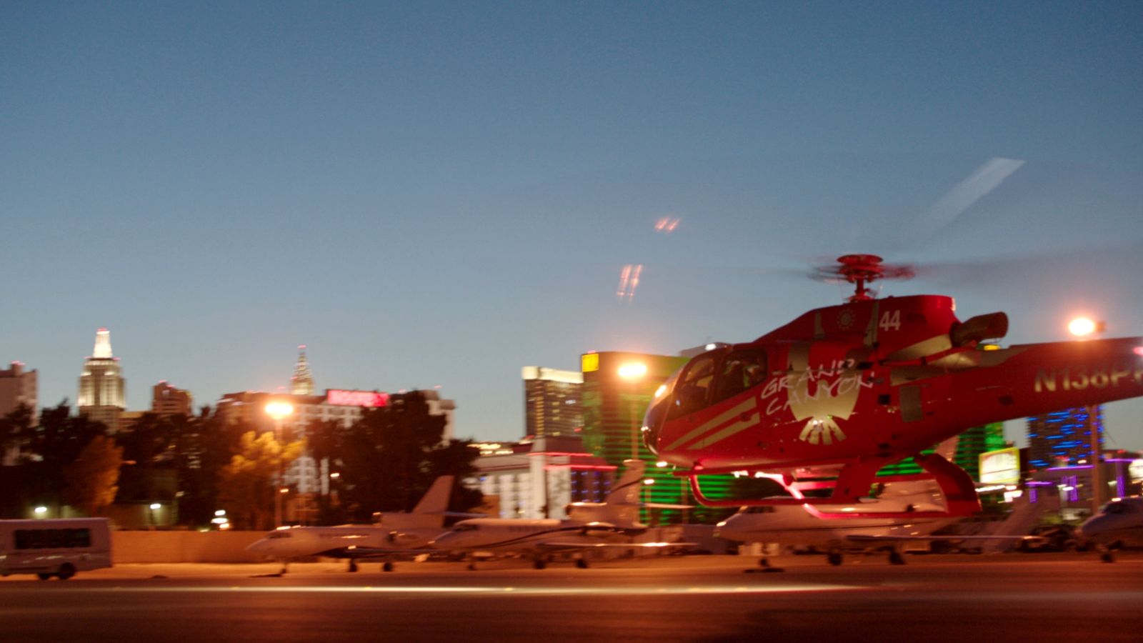 a helicopter departs from the las vegas air terminal at night