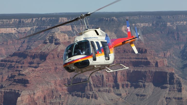 A bell 206L, all forward facing seats, flying over the deepest and widest portion of Grand Canyon National Park