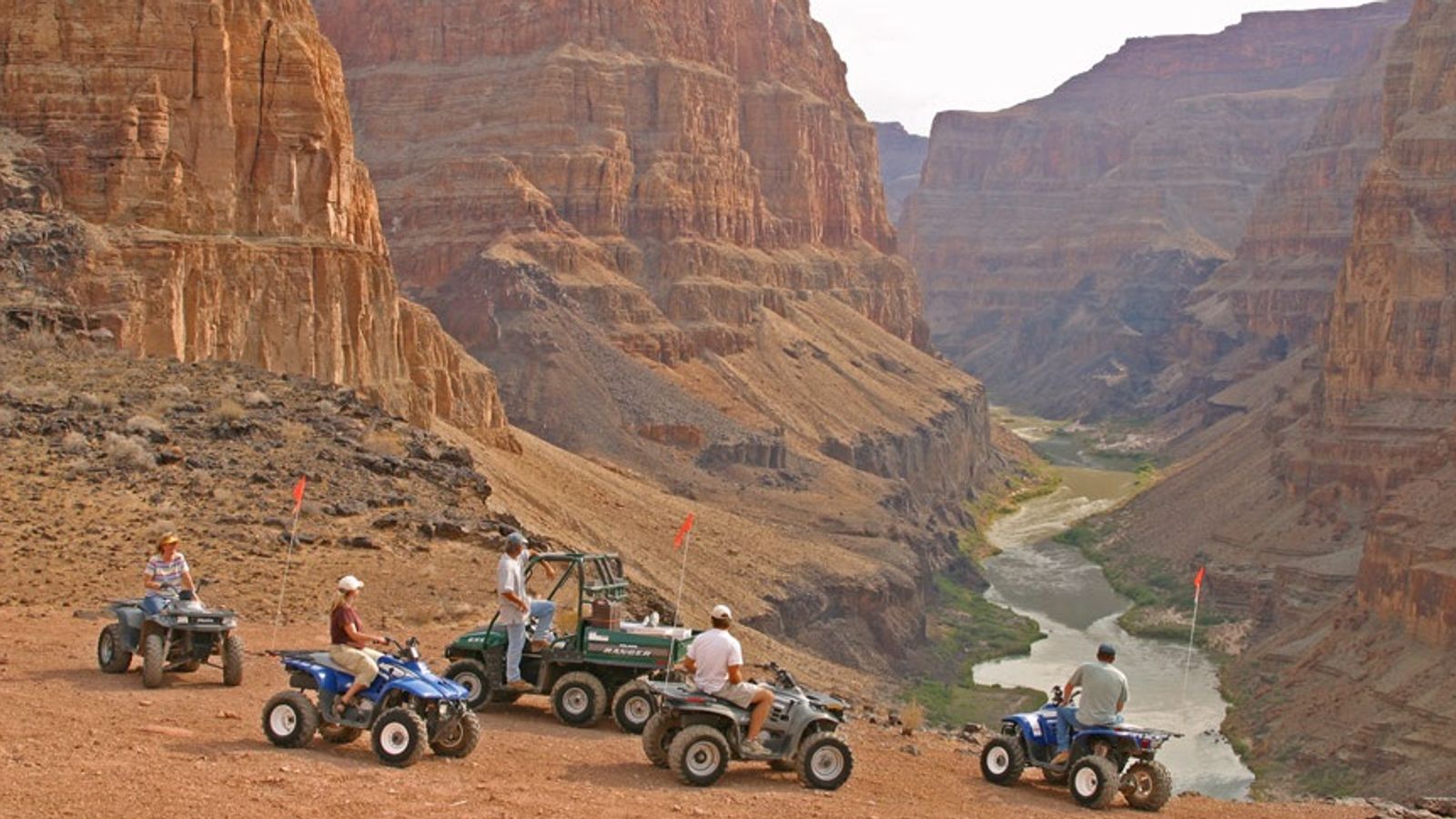 Visitors to Bar 10 Ranch stand at the edge of the Grand Canyon North during an ATV tour