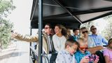 a tour group smiles and takes photos aboard a grand canyon hummer tour