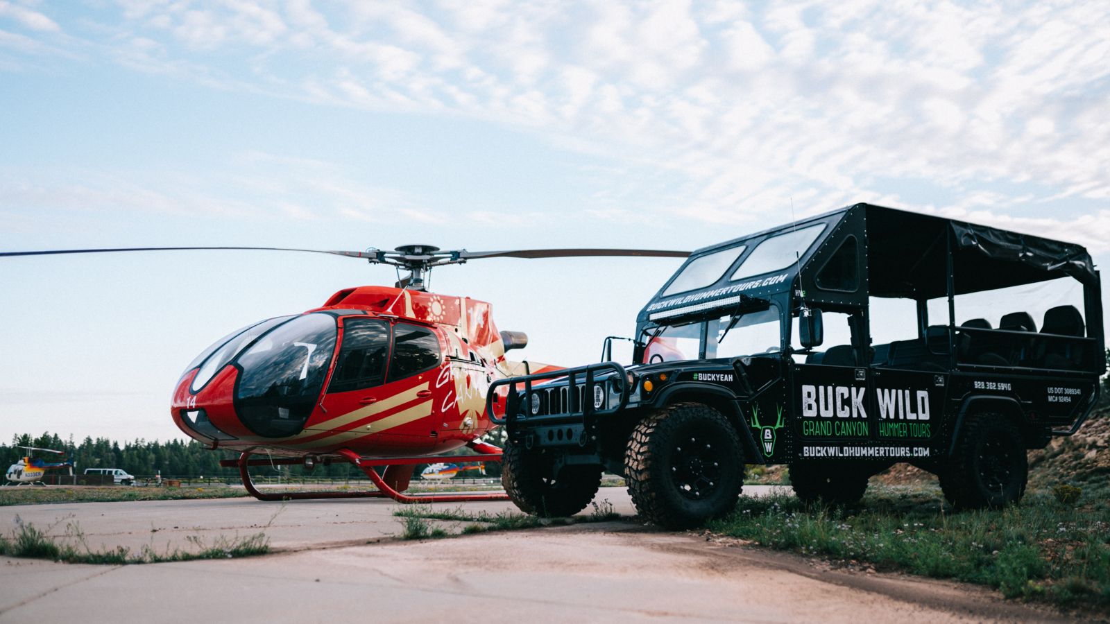 The helicopter and hummer vehicles used during this Grand Canyon tour parked on the airport tarmac