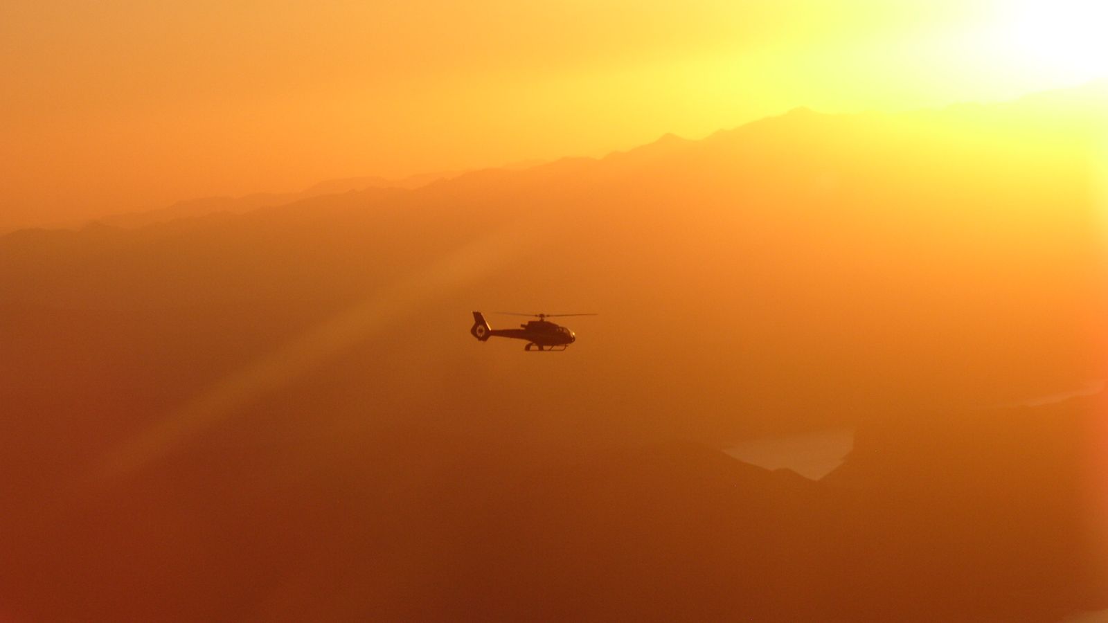 a grand canyon helicopter tour in the sky at sunset